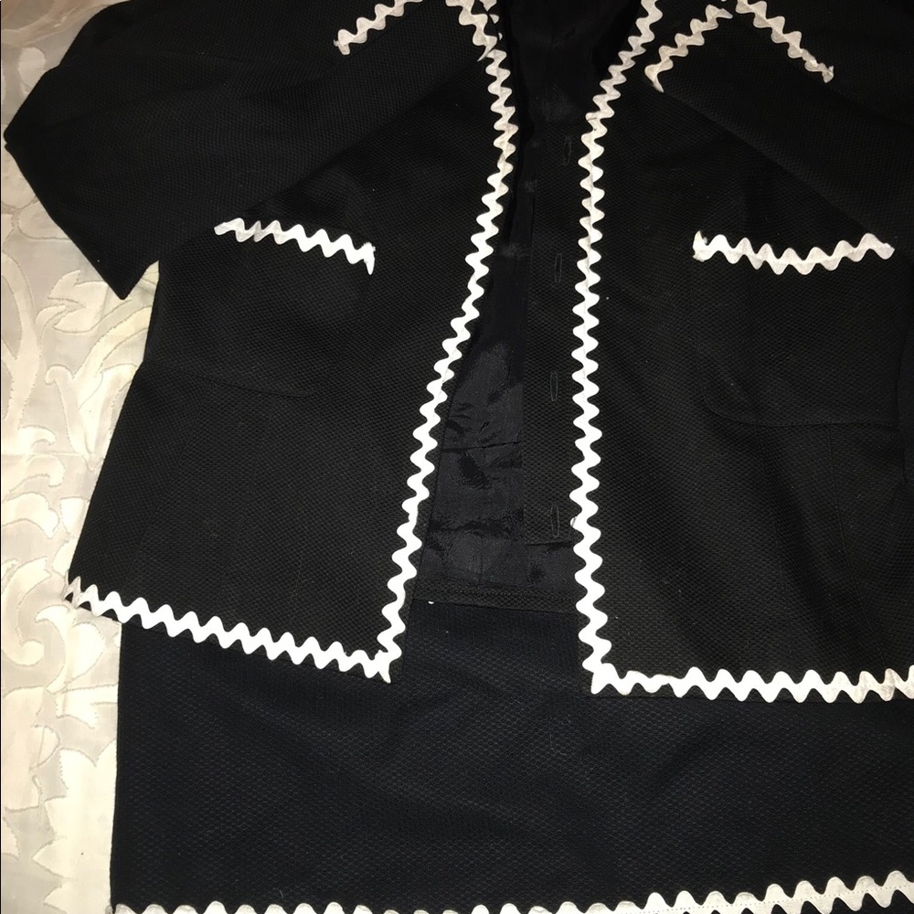 Black suit with trimmed white piping